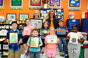 Harrison's class displays artwork they made this year. Pictured are (back row, left to right): former student Ashley Beth Jones and Harrison; (middle row): Madison Thornton, Isabelle Lindquist, Braxton Jones; (front): Tod Hall, Coen Chandler, Emma Penley and Niya Jordan. 